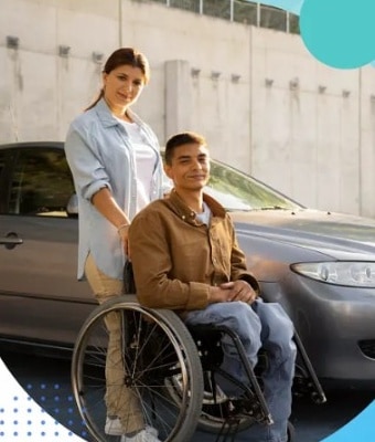 Caregiver assisting a passenger in a wheelchair beside a London's Transportation vehicle